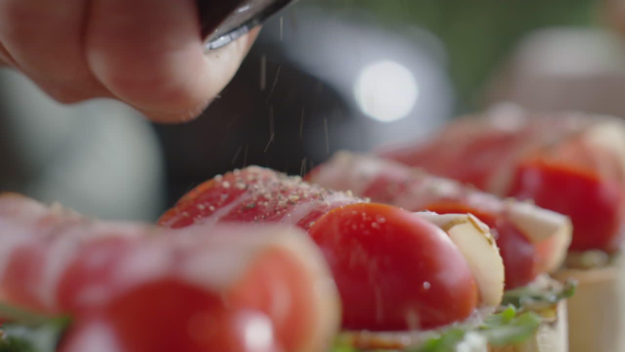 Adding Freshly Ground Pepper to Bruschettas