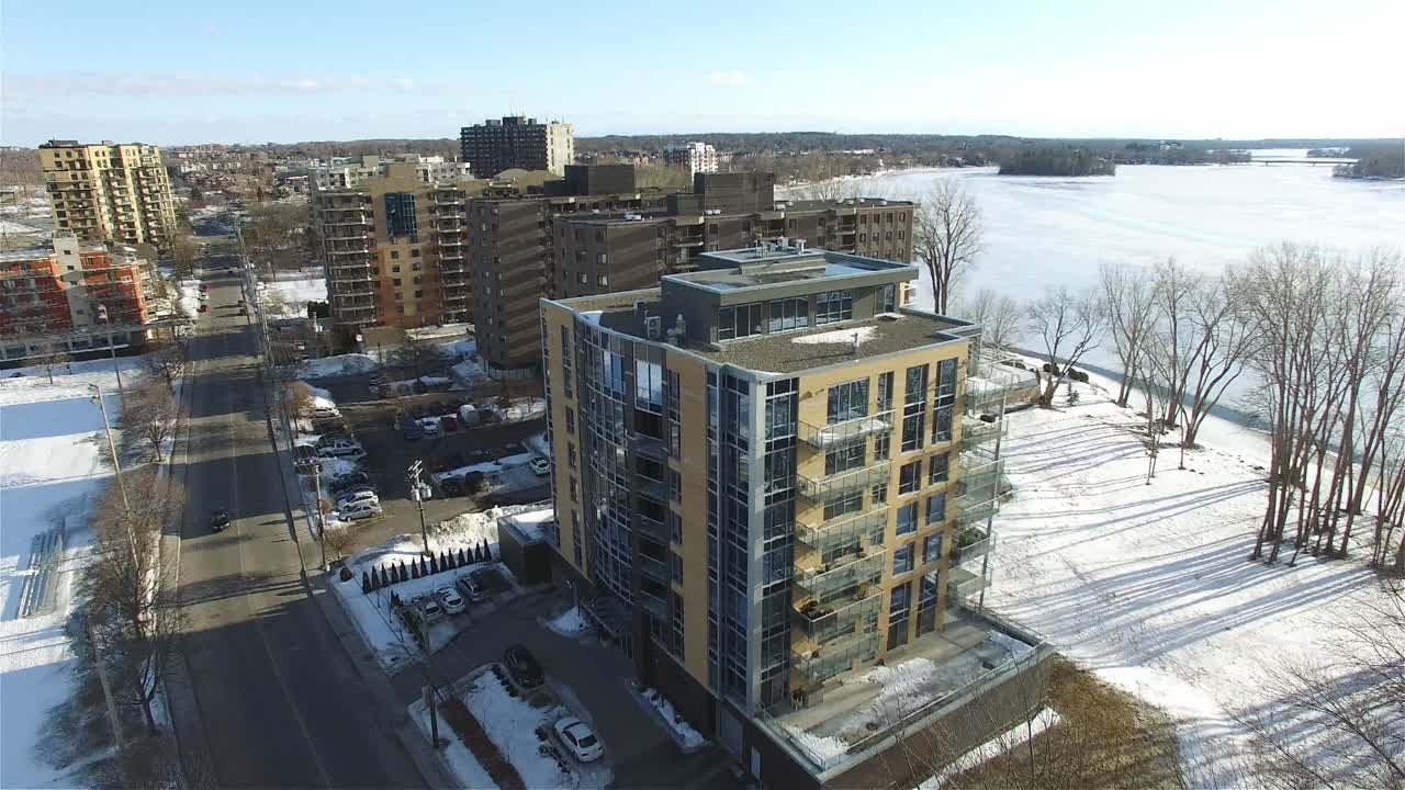 Apartment buildings surrounded with snow white landscape, aerial drone view