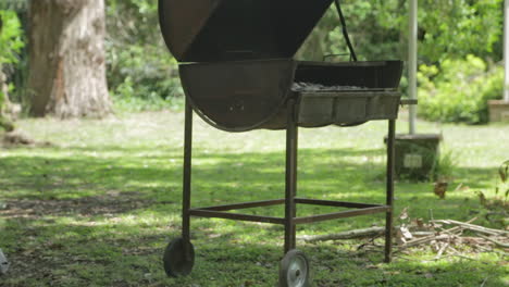 tilt up from small bonfire to a camping bbq metal barrel for cooking outdoors