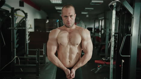 male athlete bodybuilder tightens his chest muscles pectoralis major on front view