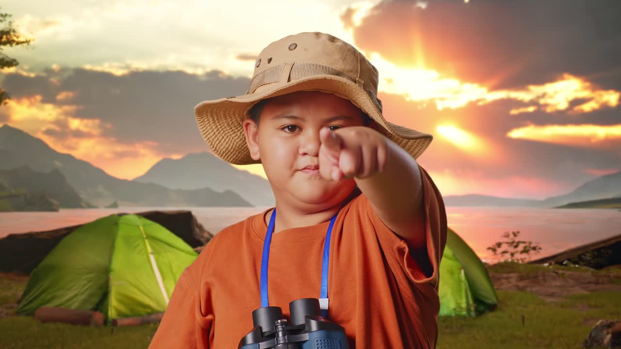 Young Boy Pointing at Something During a Camping Trip