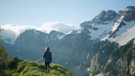 Young-man-walks-on-a-ridge-then-stops-to-contemplate-the-view