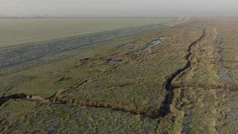 dike sea defence salt marsh the wash norfolk uk aerial landscape frosty misty morning winter coastline