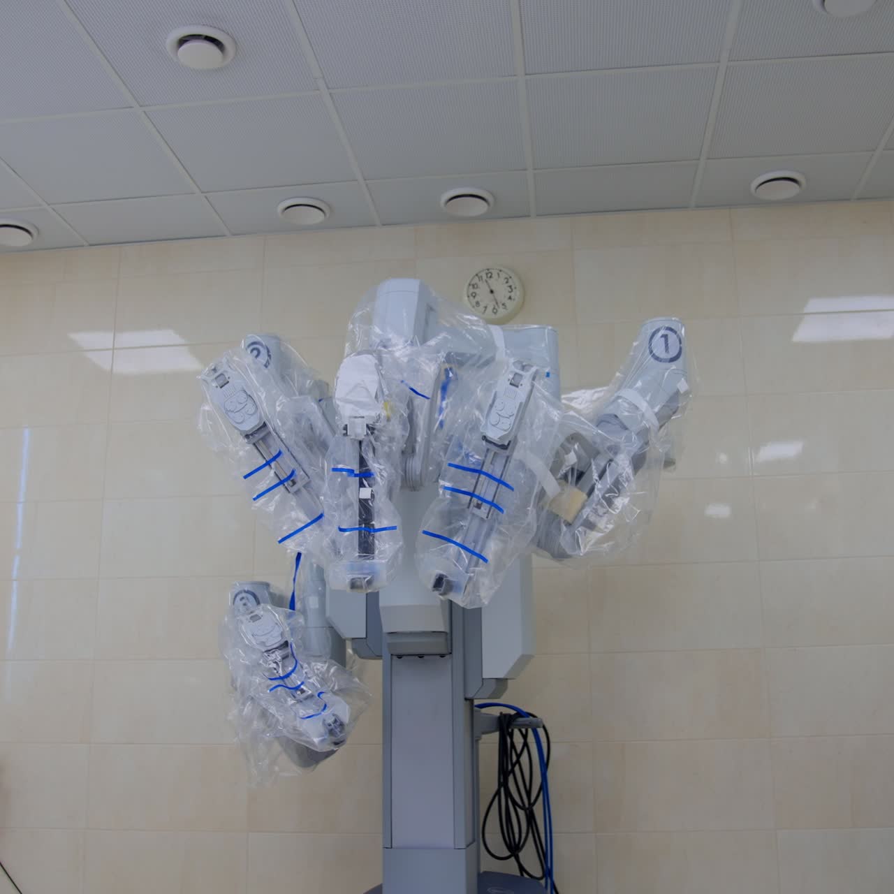 Robotic futuristic equipment covered in plastic for surgery sterility. Da Vinci device and other device and appliances in the modern surgical room