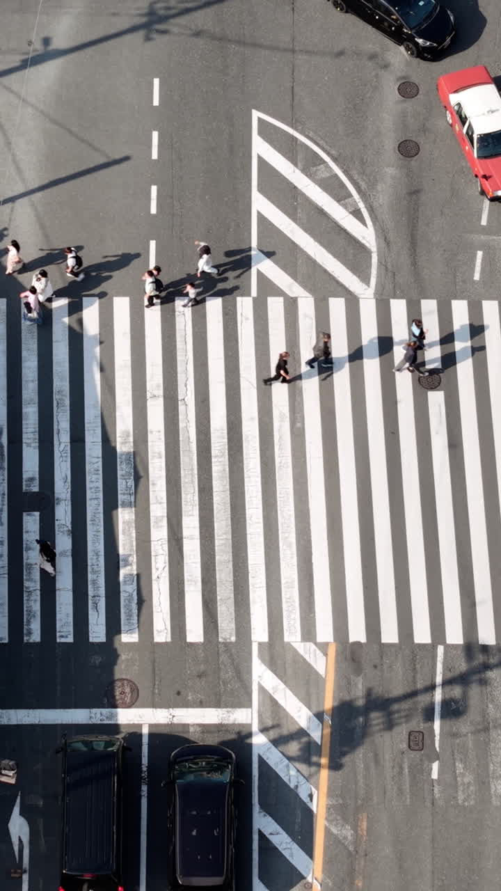 Aerial drone view of people crossing the street in Kyoto, Japan in daylight