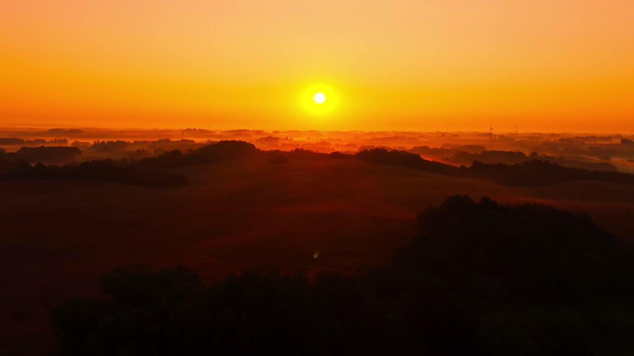 Misty sunrise horizon captured by drone evoking global risks and fragility