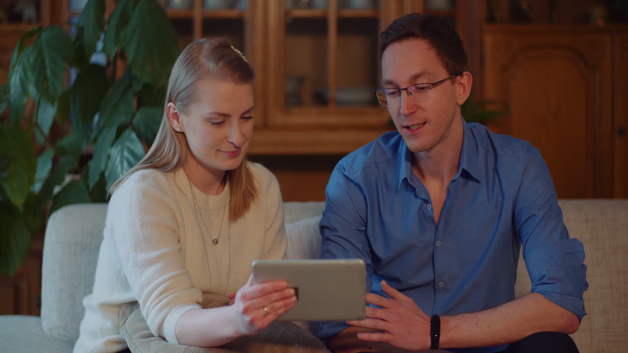 Young Man And Woman Using Digital Tablet And Watching Movie