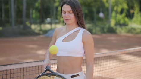 a young woman practicing tennis on an outdoor court with a coach. the coach provides guidance as the player works on her technique, perfecting her strokes in an athletic training session.