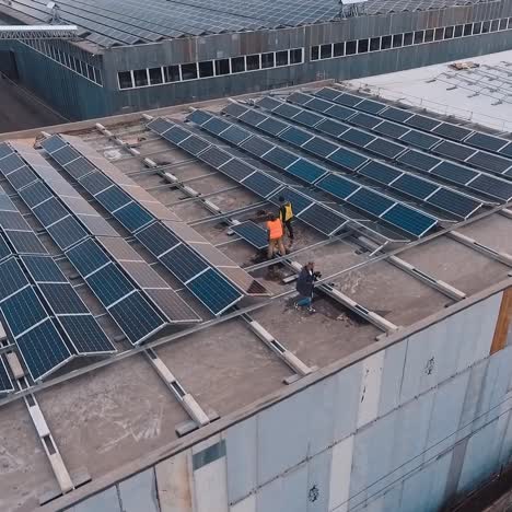 solar panels on the roof. engineers installing photovoltaic solar batteries. alternative energy. buildings with many sunny cells on roofs. aerial view.