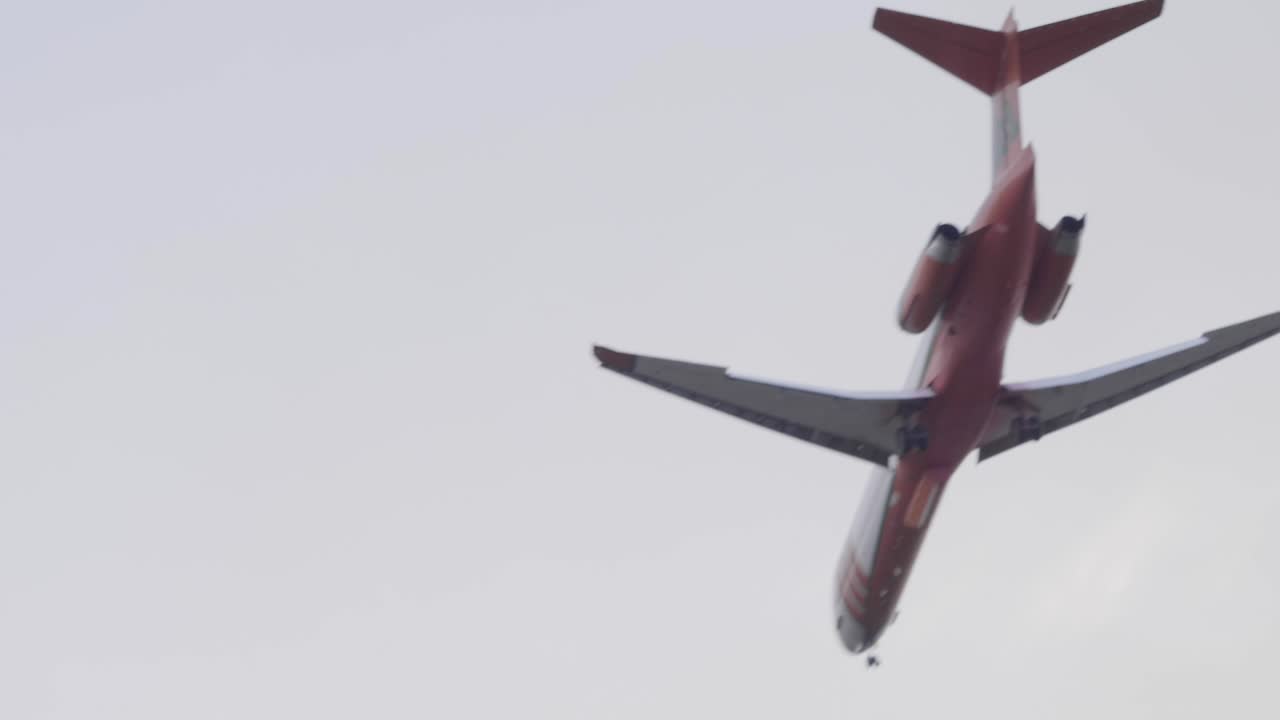 A Cal Fire McDonnell Douglas MD-87 tanker plane flies by to make a large retardant drop on the Silverado Fire in Southern California