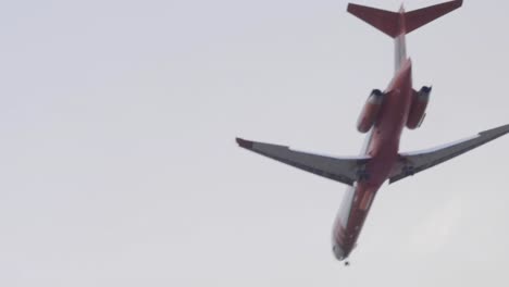 a cal fire mcdonnell douglas md-87 tanker plane flies by to make a large retardant drop on the silverado fire in southern california