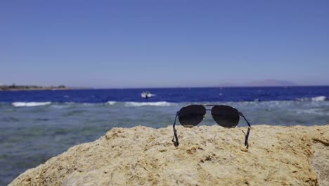 sunglasses lying on stone