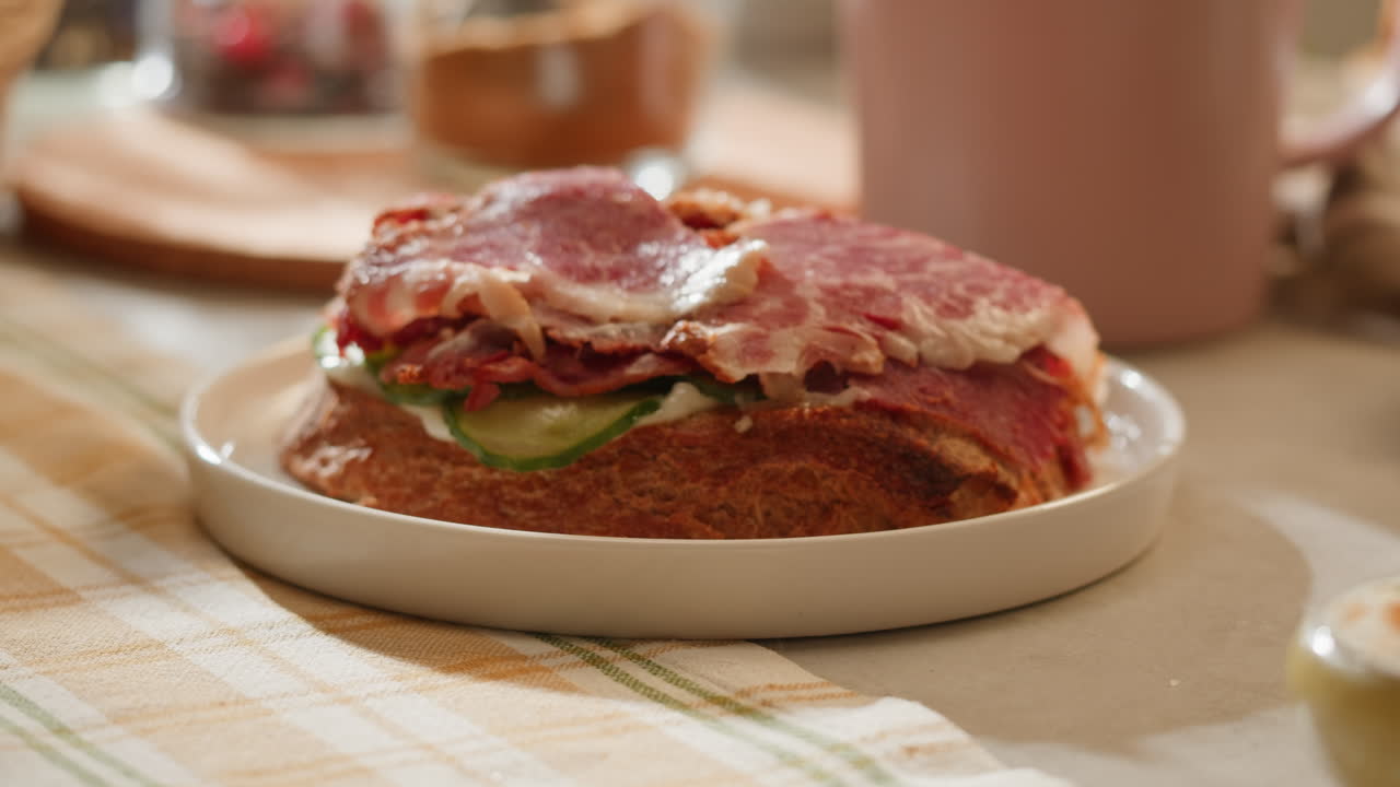 Delicious sandwich with sliced ham and cucumber