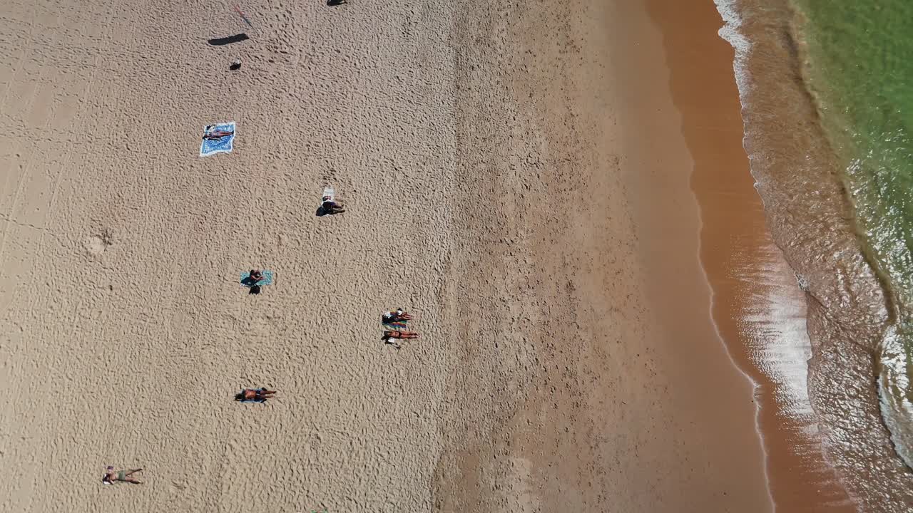 Aerial View of People Relaxing on a Sandy Beach