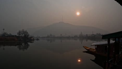 Dal lake with sun and houseboat at Srinagar, Jammu and Kashmir, new delhi, india. early morning, pan shot, 4k.