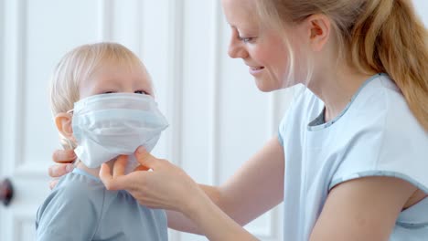 mother putting a mask on her child