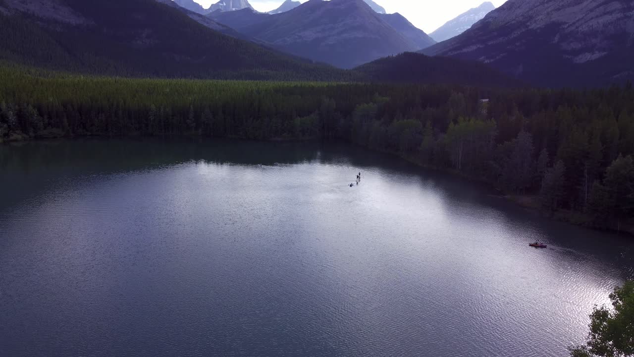 Paddle boards boat on pond in mountains and forest approached Rockies Kananaskis Alberta Canada