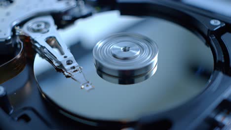 a close-up look at a hard drive reveals the intricate mechanics involved in data storage. observe the spinning disk and read/write arm as they work together in technology.