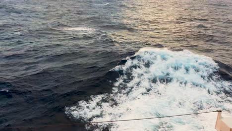 bow spray from side of cruise ship against a water background