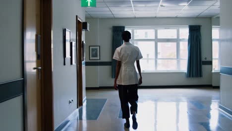 nurse walking in a hospital corridor