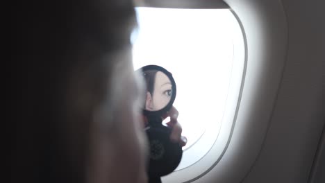 a woman in a hurry doing her make up on an airplane in stress