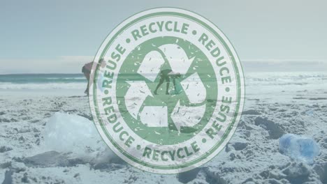 animation of recycle sign over african american man and woman with recycling bags cleaning beach