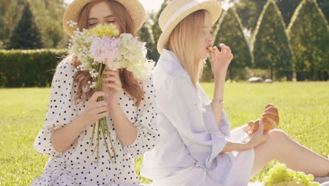 two friends enjoying a picnic in the park