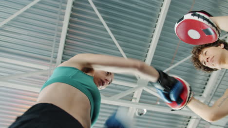 female boxers training with pads