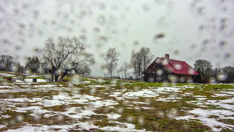 cabin in a field on a day with rain and sleet - time lapse