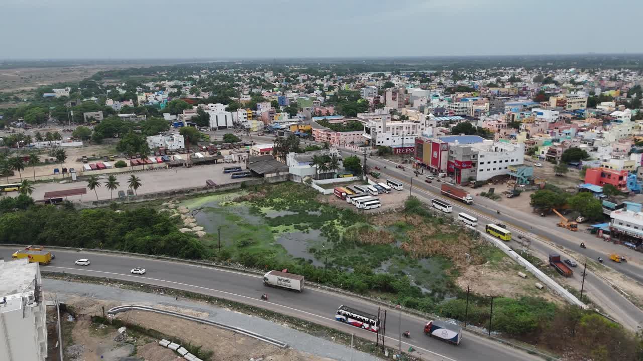Aerial View of a Bustling Indian City with Roads and a Bus Terminal