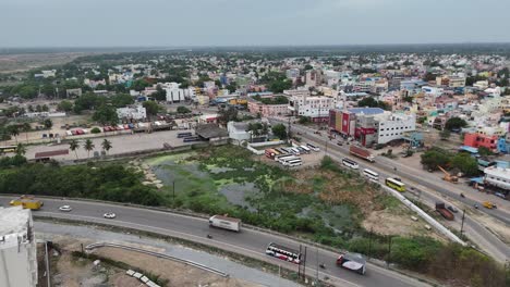 aerial view of a bustling indian city with roads and a bus terminal