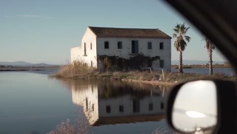 abandoned house reflecting in water