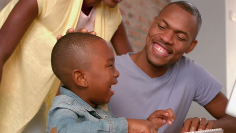 Happy-family-using-computer-together