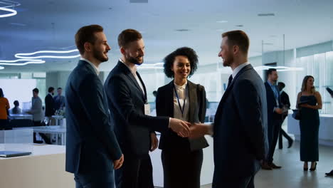 business professionals shaking hands at a conference or networking event