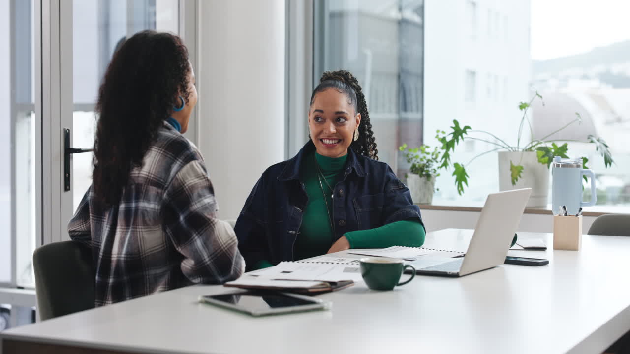 Two Businesswomen Celebrating Success with a High Five in a Modern Office