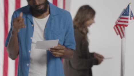 confused man stands at ballot box in american election deciding how to cast his vote 1