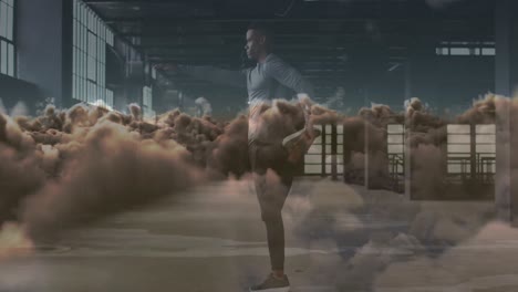 animation of clouds over african american sportsman exercising