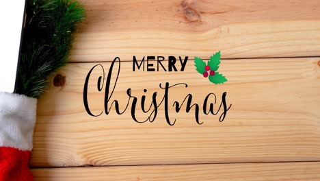 animation of merry christmas text and decorations on wooden background