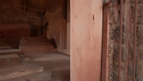 Interior-De-Un-Antiguo-Fuerte-Con-Paredes-Rojas,-Puertas-Arqueadas-Y-Una-Sensación-De-Misterio-Histórico.