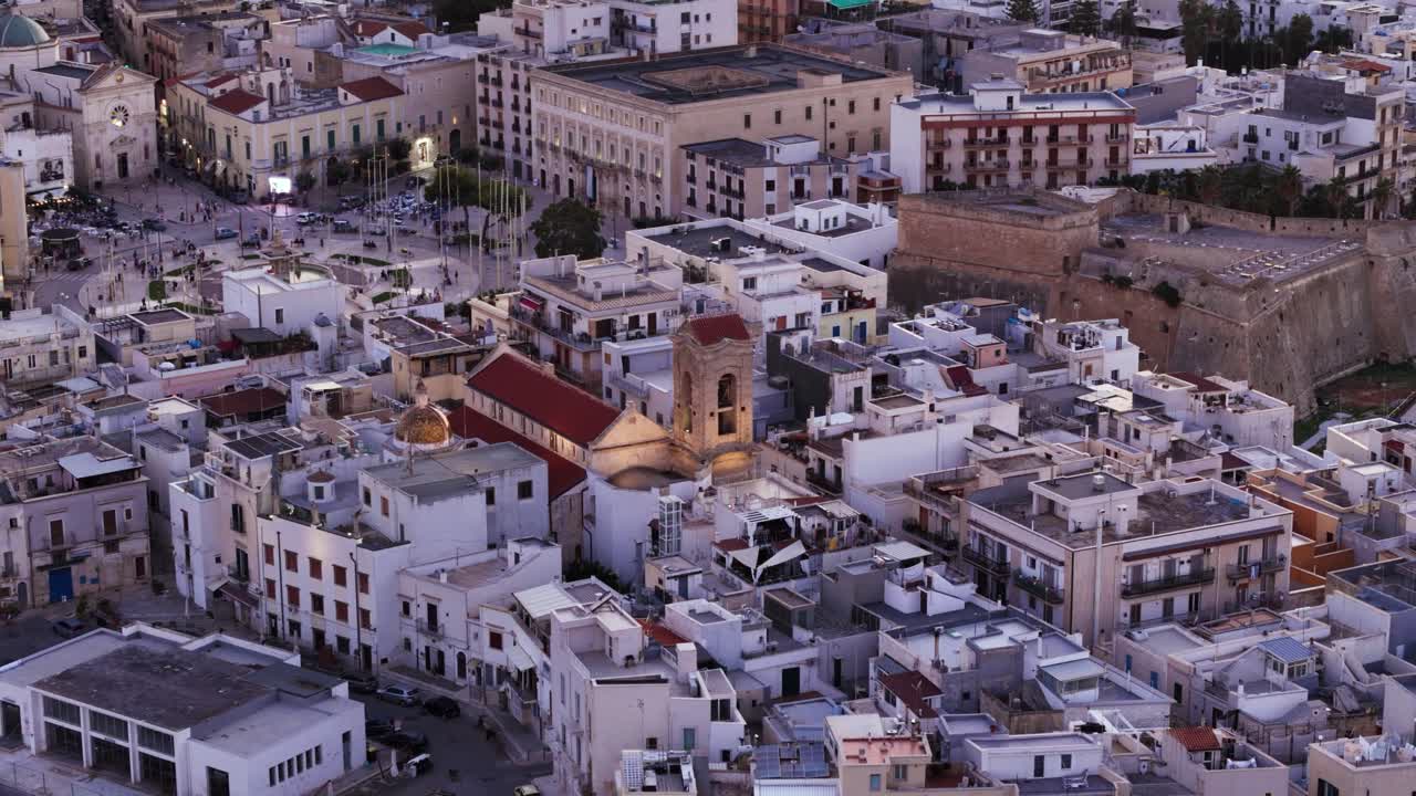 Church and downtown of small Italian township, aerial orbit view