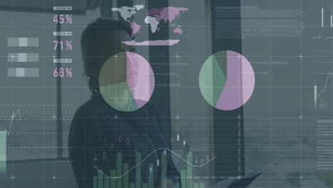analyzing data charts on transparent screen, business professional focused in office