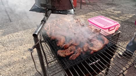 grilling meat on a barbecue with rising smoke.