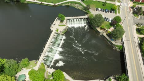 dam on rogue river in rockford, michigan with drone video overhead moving in