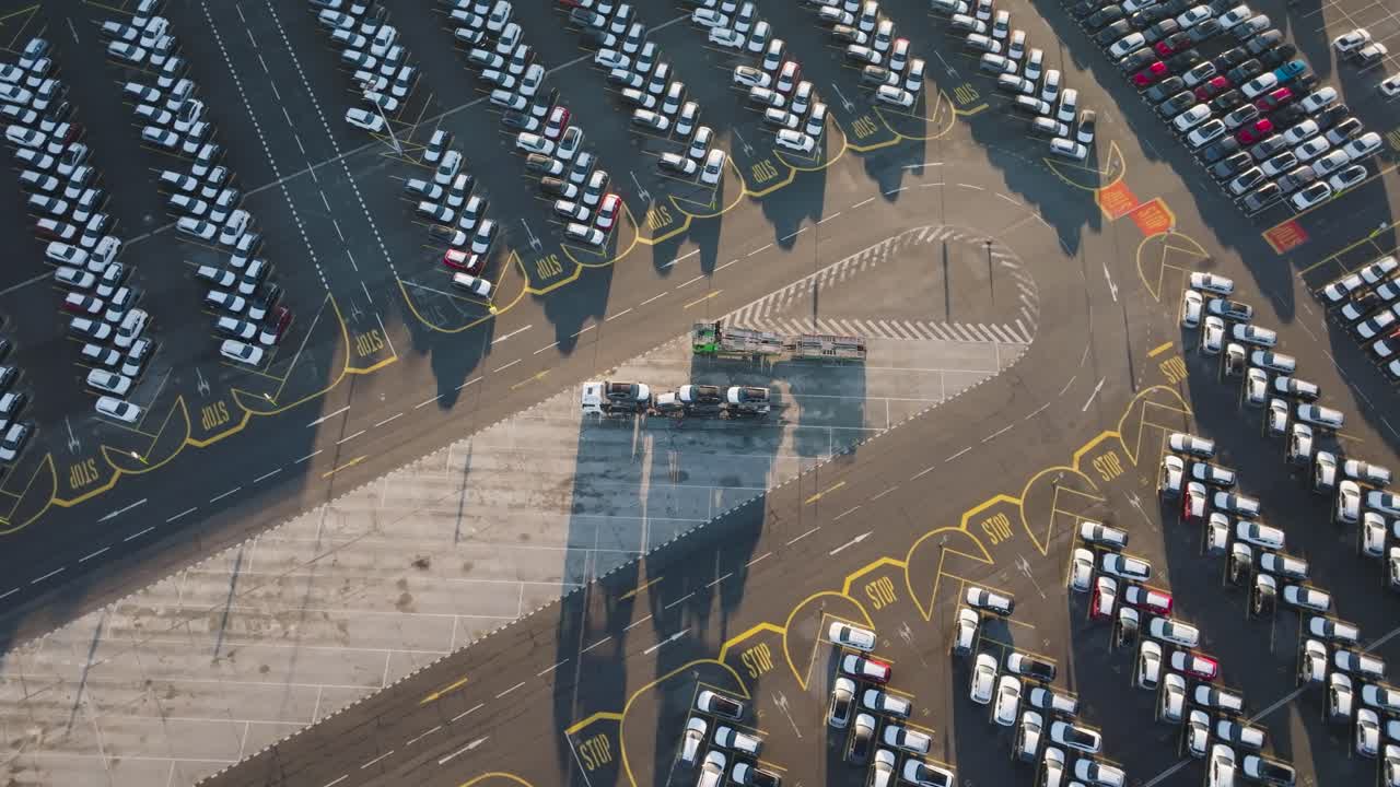 Aerial - car carrier trailer with cargo at mass storage parking lot