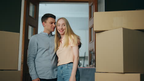 new tenants standing apartment looking living room interior. family moving house