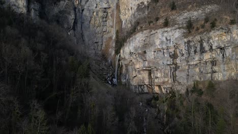 The-majestic-beauty-of-rugged-mountain-terrain-adorned-with-cascading-waterfalls,-is-located-near-of-Walensee-Unterterzen,-Switzerland