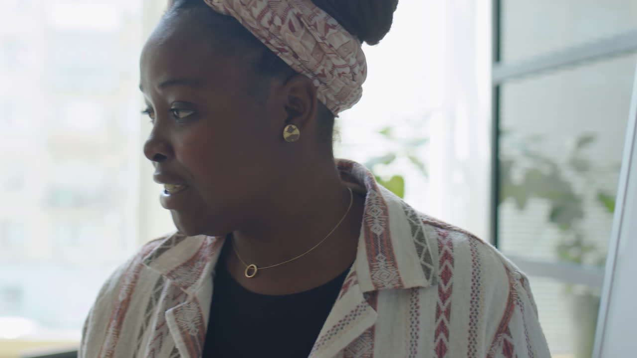 Female Business Coach Giving Presentation in Office