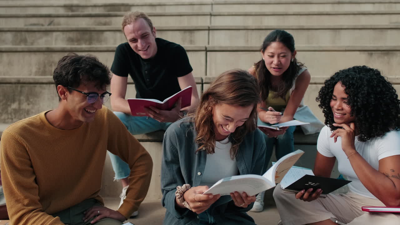 Happy female and male students preparing for exams. Multiethnic team,