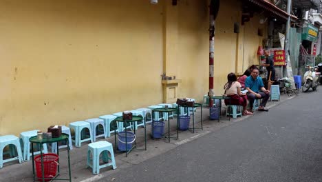 people enjoying street food in hanoi, vietnam