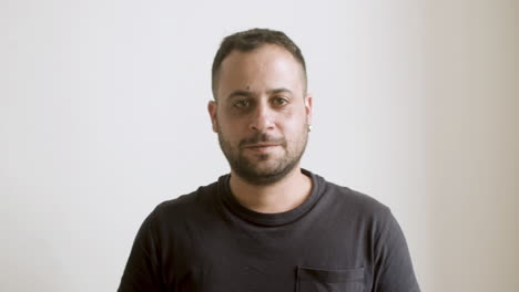 cheerful bearded man looking at camera.